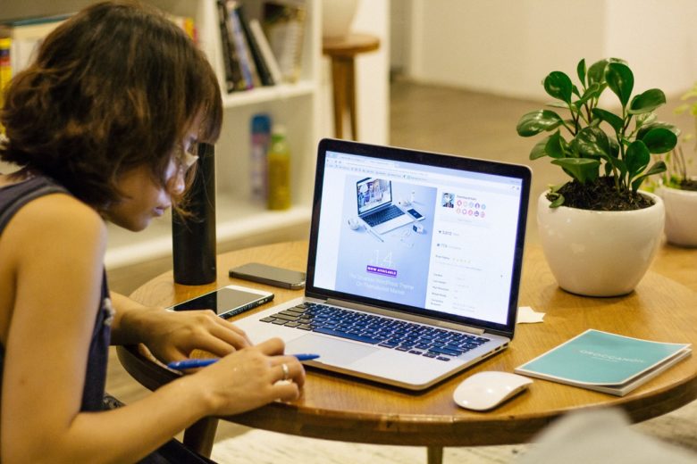 A woman sitting in front of a laptop